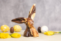 Cocoa Loco fairtrade marbled chocolate easter bunny on a cream worktop next to some easter eggs and daffodils