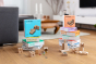 Cuboro plastic-free wooden marble run sets stacked in 2 piles on a wooden floor