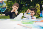 2 boys playing with coloured bubbles in the Dr Zigs eco-friendly bubble painting kit