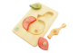 Pieces of the sustainable Drei Blätter children's apple peg puzzle on a white background
