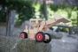 Close up of the Fagus handmade telescopic loader vehicle toy on a large rock
