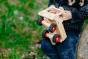 Close up of a child holding the large Fagus wooden truck toy in a grassy field