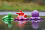 Green Rubber Toys Sea Friends Bath Toy Set pictured in a puddle 