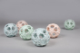 A selection of Hevea Natural Rubber Upcycled Star Activity Balls on a grey background