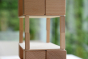 Close up of the Just Blocks plastic-free wooden toy shapes stacked in an intricate tower