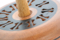 Close up of the engravings on the top of the Mader eco-friendly wooden Leporello spinning top toy