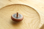 Mader wooden Leporello spinning top spinning on a Mader wooden spinning plate