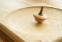 Mader wooden duet spinning top toy on a Mader wooden spinning plate