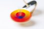 Naef premium bauhaus optical mixer coloured spinning tops rotating on a white background