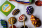 Close up of some pebbles painted with the Natural Paint kit in some colourful patterns