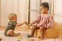 Girl and boy playing with the oli and carol natural rubber soft teething toys