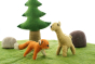 Close up of the Papoose felt fox and fawn toy figures on a green play mat in front of a Papoose tree