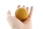Close up of a hand holding a Papoose plastic-free soft felt earth ball on a white background