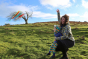 Woman and young child playing with a kite in a grass field wearing the Piccalily rainbow stripe pull up trousers