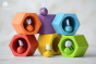 Plan Toys Bee Hives - Rainbow, colourful wooden bees in their corresponding coloured hexagonal pot. White background.