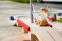 Close up of Plan Toys car on top of the Plan Toys Wooden road set