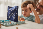 Close up of young boy and man looking at their pieces on the PlanToys Guess my Planet battleships board game