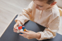 Close up of young boy holding the PlanToys rectangular stacking blocks puzzle toy
