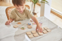 Young boy sat at a table playing with the PlanToys wooden animal memory game