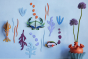 Studio Roof plastic-free craft sea creature wall decorations on a white background next to a potted plant