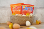 Tonys chocolonely eco-friendly mini easter egg pouches in a basket surrounded by small wooden eggs and chick toys