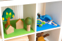 Toys by nature eco-friendly wooden kallax inserts on a white Kallax unit covered in wooden toys.