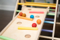 Close up of wooden balls rolling down a ball run made with the Triclimb wooden Miri slide and pastel Miri sticks
