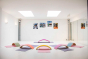 Wobbel Beech Wood balance boards set out in a semi circle in a white mirrored room