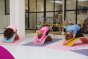 Group of children using Wobbel Beech Wood balance boards for yoga