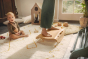 Close up of woman's feet on a Wobbel Sup balance board next to a toddler sat on the floor