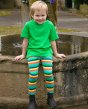 a child wearing organic cotton leggings for babies and children with elasticated waist and stretchy cuffs in a bright rainbow all-over design from piccalilly