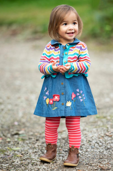 Young girl stood on some gravel wearing the Frugi fairy little norah striped tights