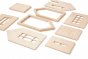 Pieces of a babai eco-friendly magnetic dollhouse spread out on a white background