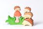 Bumbu wooden hedgehog toys stacked on a white background next to the eco-friendly wooden Bumbu grass and mushroom set 