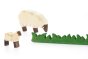 Close up of the Bumbu eating sheep, lamb and wooden grass figures on a white background