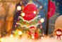 Close up of the Divine fairtrade milk chocolate advent calendar stood up on a white blanket behind some fairy lights