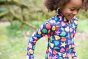 Close up of a girl running in the Frugi eco-friendly seashells runa swimsuit