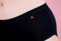 Hey Girls Mid Waist Black Reusable Period Pants worn by a person against a pink background