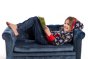 Child laying on a sofa reading a book, wearing the maxomorra kids classic lightning print hoodie