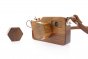 Close up of O-WOW handmade maple wood camera toy on a white background