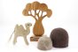 Papoose childrens felt camel toy on a white background next to a wooden African tree toy and some felt rocks
