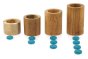 Papoose stacking wooden tubes lined up in order of size next to some Grapat counters for learning number play