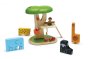 Plan Toys childrens stacking wooden animal jigsaw pieces laid out on a white background next to a plan toys tree swing play set on a white background