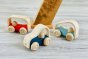 Close up of the Plan Toys eco-friendly wooden vroom vehicle toys on a grey wooden floor