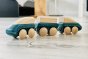 Plan toys plastic free wooden hybrid train toy on a grey wooden floor