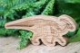 Reel wood eco-friendly parasaurolophus figure in front of a green plant