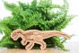 Reel wood eco-friendly allosaurus dinosaur figure in front of a green plant