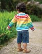 child wearing organic cotton knitted cardigan in alternating rainbow and light grey stripes from frugi