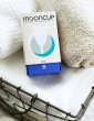 Mooncup box size B in a wash basket leaning on towels