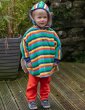 a child wearing organic cotton poncho with a bright rainbow stripe design, co-ordinating stretchy blue cuffs and lined with super soft and snuggly Sherpa fleece from piccalilly